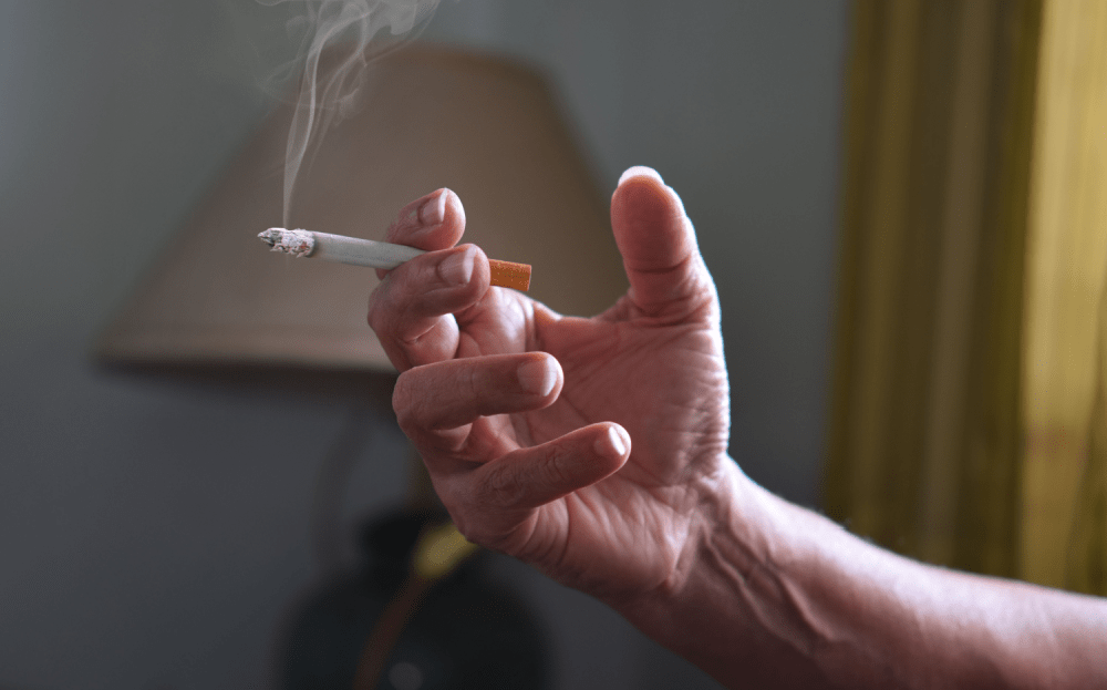 A Cigarette being smoked in the house, leaving a lingering odour.